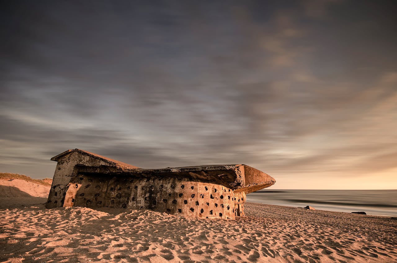 A weathered World War II bunker on Hanstholm beach, Denmark at sunset.